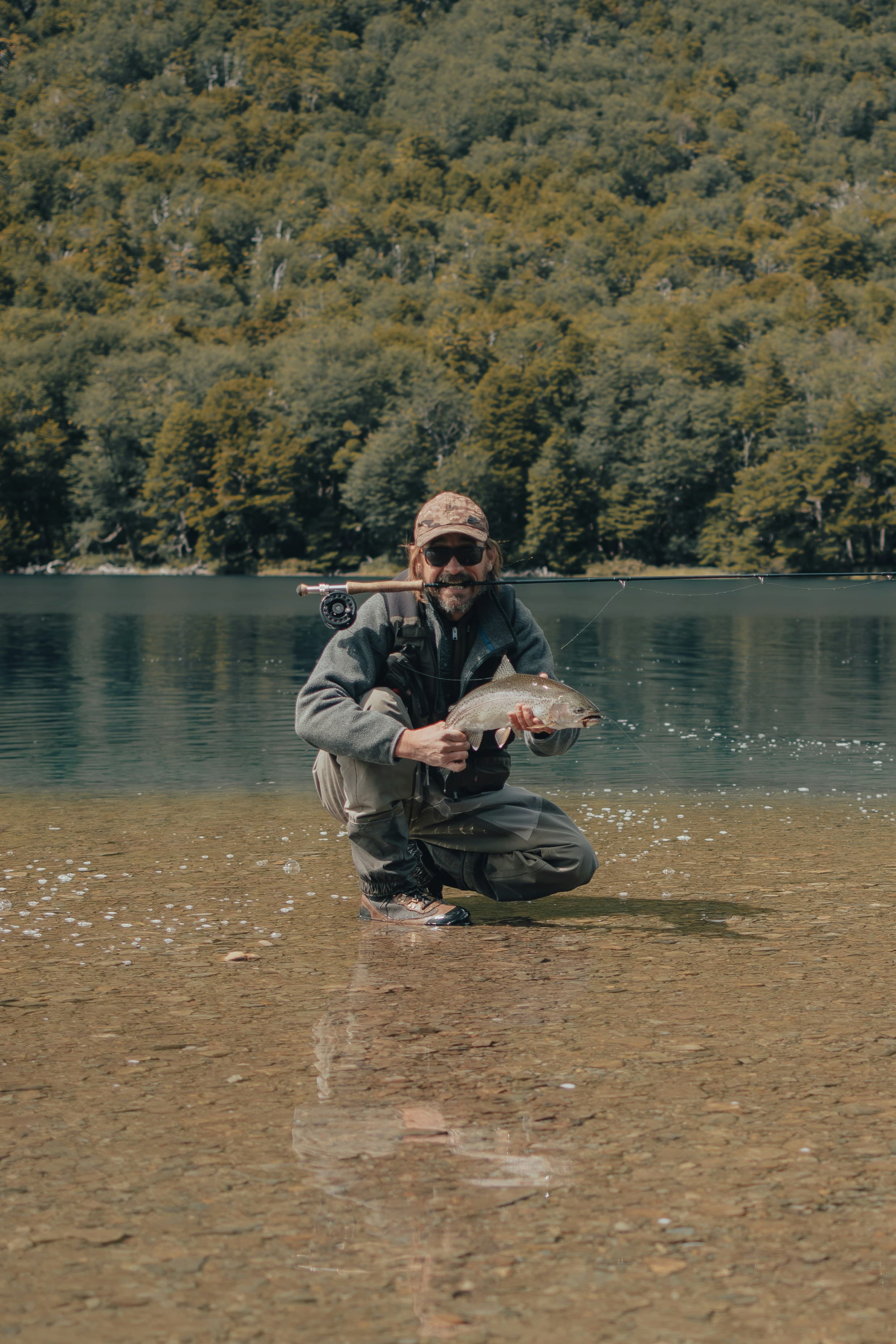 Guide holding a fish in the river